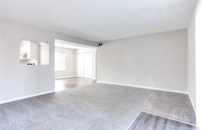 an empty living room with gray walls and a gray rug  at Barcelo at East Cobb, Marietta, GA