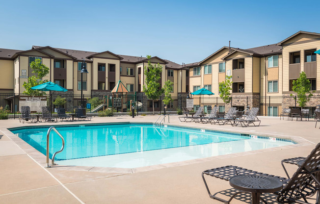 our apartments have a swimming pool with chairs and umbrellas