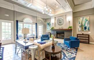 a living room with blue furniture and a fireplace
