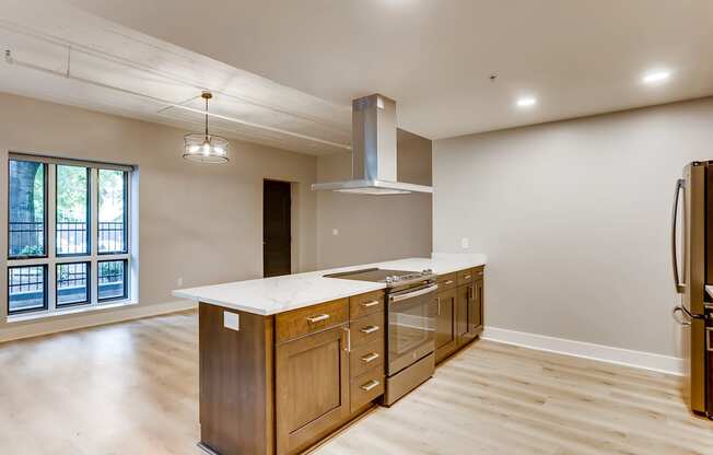 A kitchen with wooden cabinets and a large island.