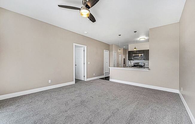 open living room with a ceiling fan at Trade Winds Apartment Homes, Elkhorn, NE