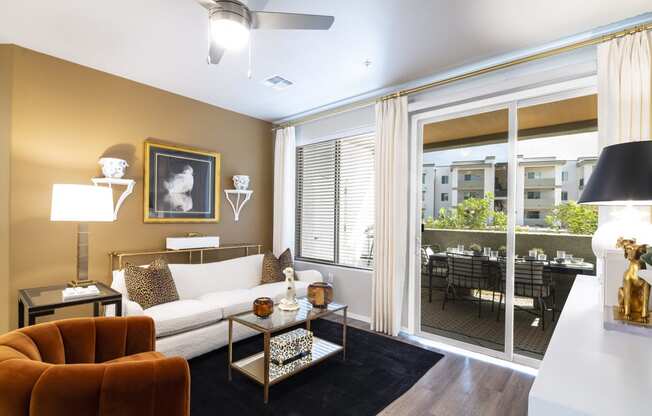 a living room with a large window and a couch and a table