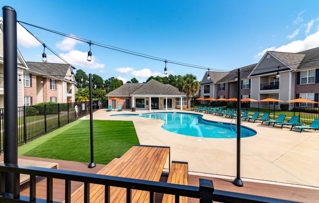 our apartments have a large pool and deck with chairs