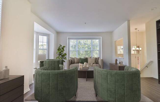 A living room with two green chairs and a couch.