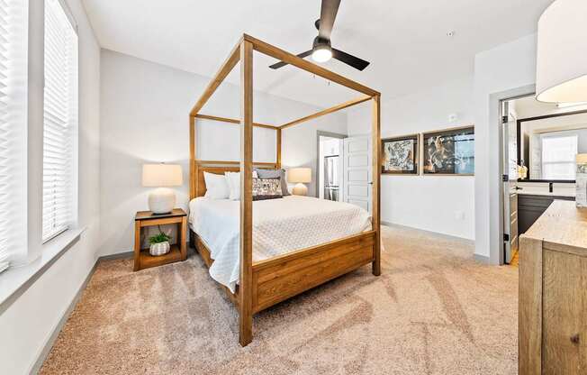 A bedroom with a four poster bed and a carpet