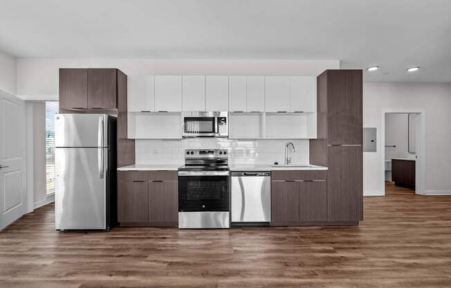 A modern kitchen with a refrigerator, stove, and oven.