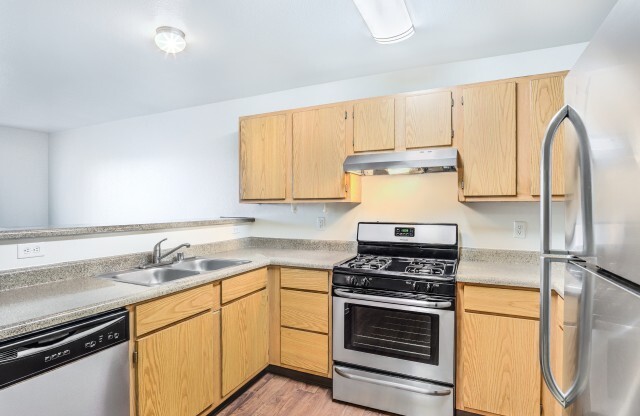 Las Vegas NV Apartments-Portola Del Sol Apartments Kitchen With Stainless Appliances And Hardwood-Style Flooring