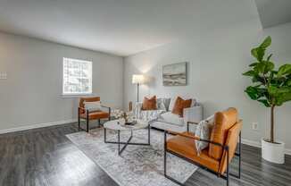 a living room with a couch and chairs and a table