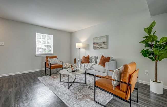 a living room with a couch and chairs and a table