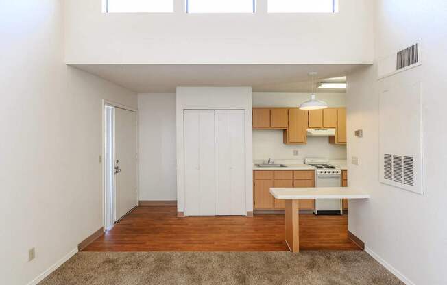 A kitchen with white cabinets and a wooden island.