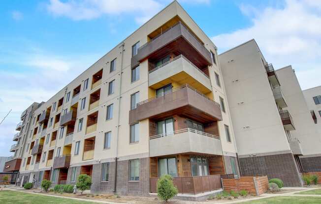 a large apartment building with balconies and a blue sky