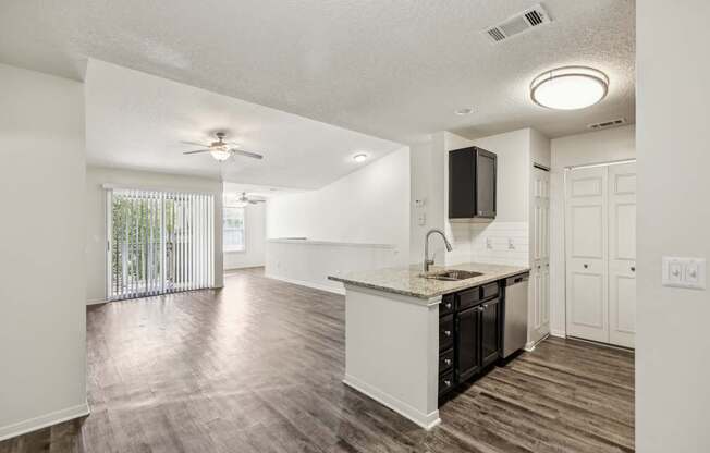 A kitchen with a sink and a fan.