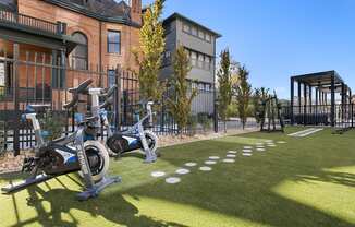 a group of exercise bikes parked outside of a building