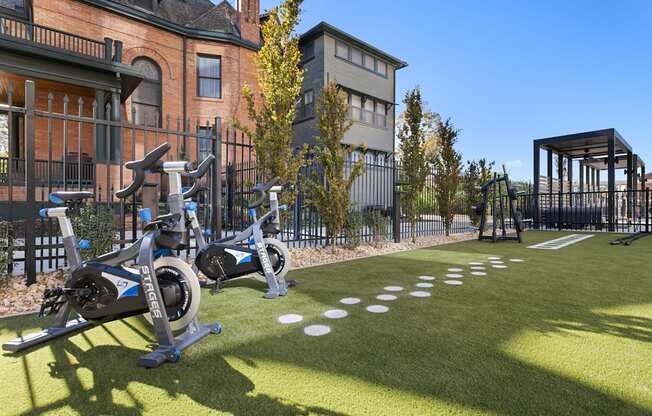 a group of exercise bikes parked outside of a building