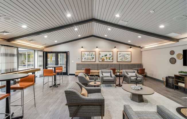 A spacious waiting area with a variety of seating options and artwork on the walls.