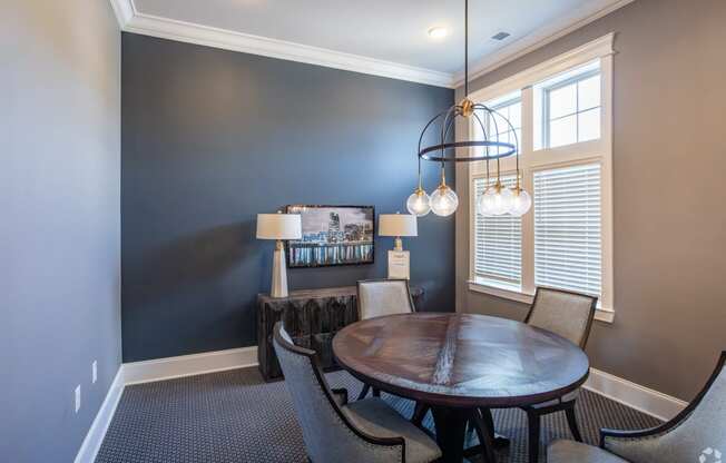 a dining room with a table and chairs and a chandelier