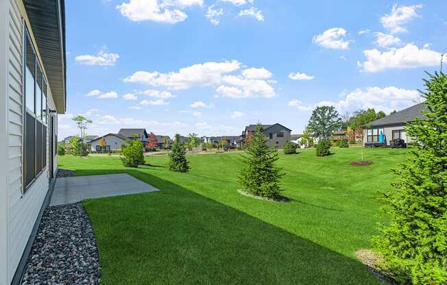 the view of a yard with houses in the background