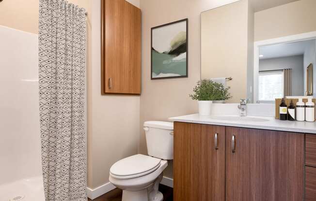 a bathroom with a toilet and a sink and a shower