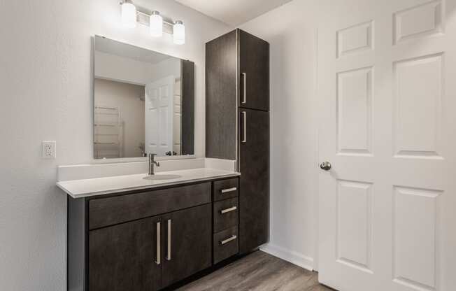 an empty bathroom with a sink and a mirror