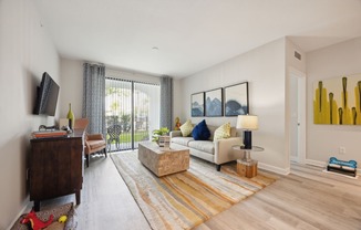the living room of an apartment with a couch and a tv