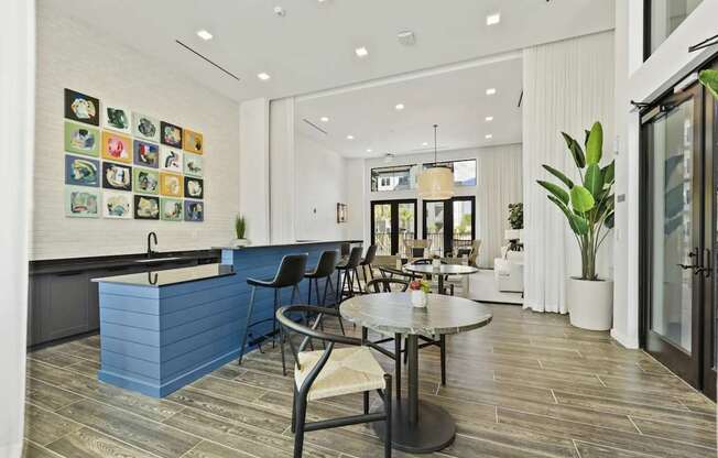 A modern dining area with a blue counter and a round table.