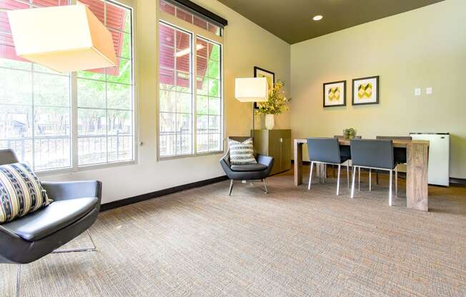 a room with a table and chairs and large windows  at Riverset Apartments, Tennessee, 38103