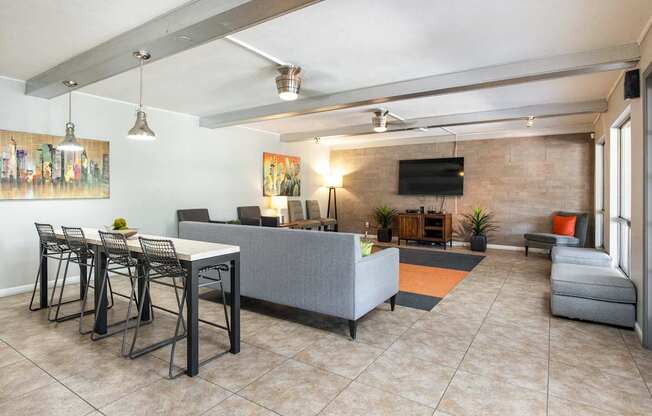 a living room with a couch and a table with chairs