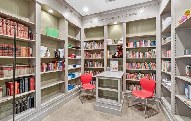 A room with bookshelves and a sign that says "like you places your feet can't".