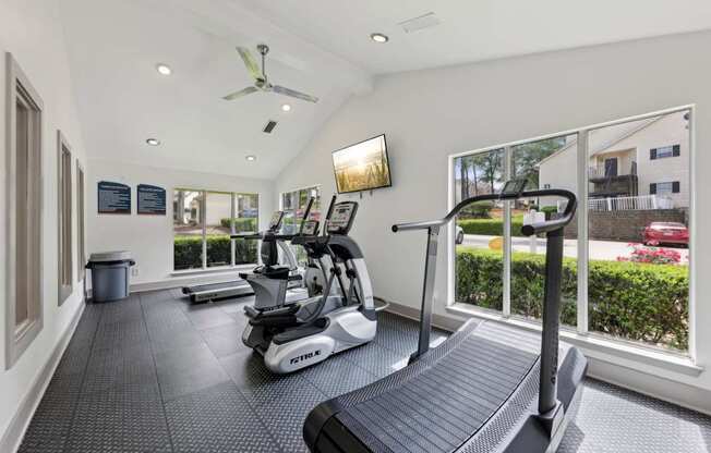 A fitness center with treadmills and ellipticals at Gwinnett Square Apartments in Duluth, GA