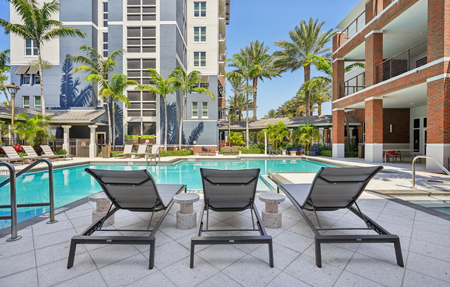Lounge Chairs at Outdoor Pool at One Plantation Apartments in Plantation, FL 33324
