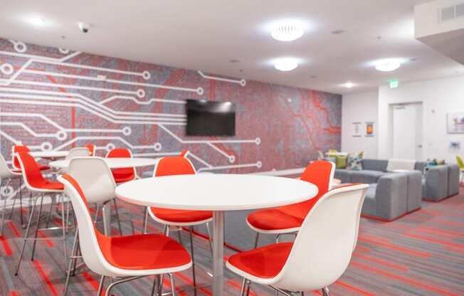 a room with a table and chairs and a wall with a television at 20 Midtown, Alabama, 35233