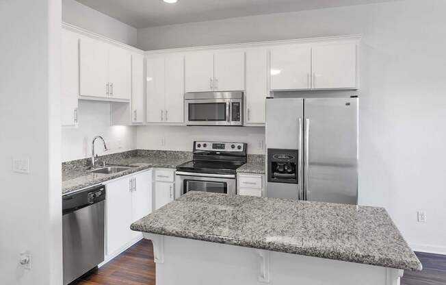 a kitchen with granite counter tops and stainless steel appliances