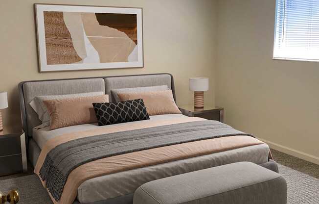 A bedroom with a bed, pillows, a ceiling fan, and a painting on the wall.