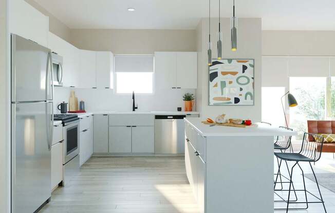 A modern kitchen with white cabinets and a large island.
