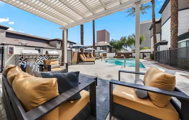 A patio with a pool and a white canopy.