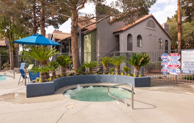 a hot tub in a pool in front of a house