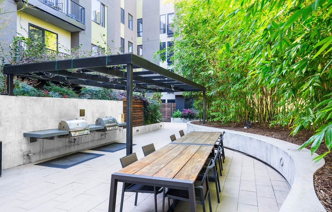 A patio with a table and chairs under a roof.