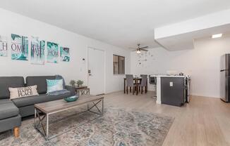 a living room filled with furniture and a flat screen tv