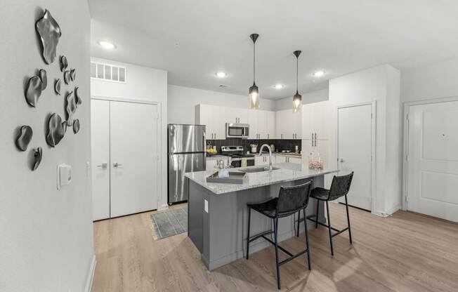 A kitchen with a white counter and a sink. at Bridge at Tech Crossing, Austin, 78753
