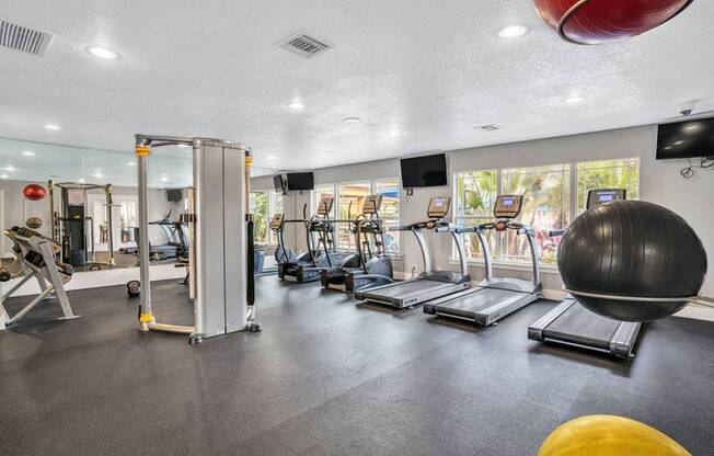Fitness Center with treadmills facing a window view of the pool