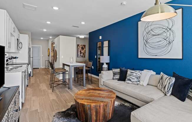 a living room with a blue wall and a couch and a table at Alton Jefferson Park, Denver, CO