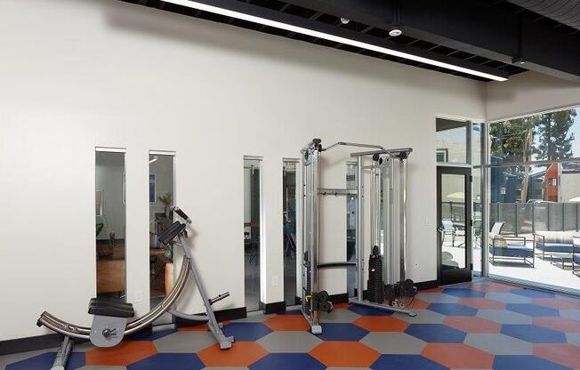 Fitness center with weightlifting equipment at Horizon Apartments in Santa Ana, California