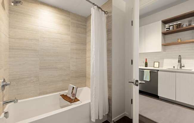 A bathroom with a tub, sink, and shower.