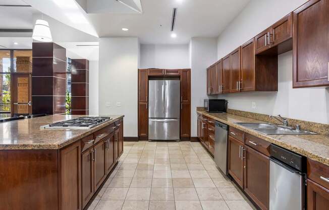 A kitchen with brown cabinets and a stainless steel refrigerator.