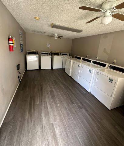 a room with white washers and dryers in it