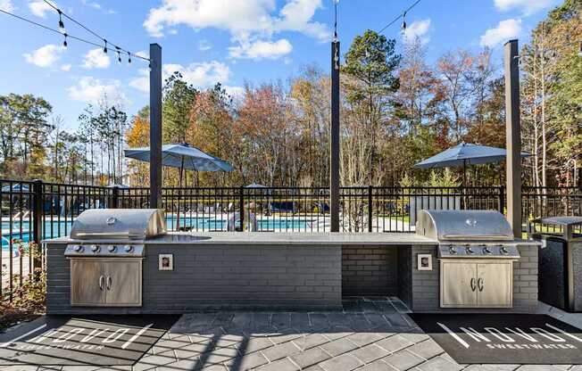 A backyard with a grill and a pool.