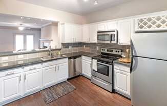 This is a photo of the kitchen of the 1661 square foot 3 bedroom, 3 and a half bath floor plan at The Brownstones Townhome Apartments in Dallas, TX.