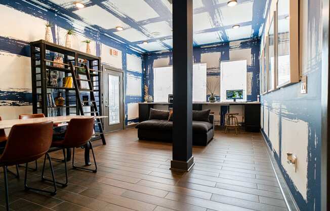 a living room with blue walls and a table and chairs