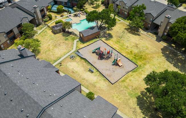 arial view of a home with a swimming pool and backyard