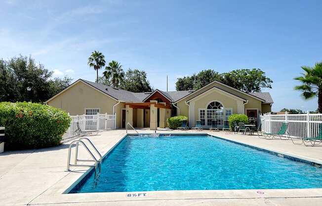 A swimming pool in front of a house.